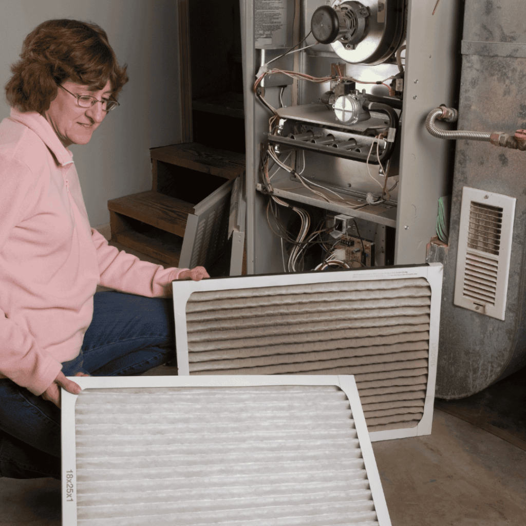 woman replacing filter on furnace