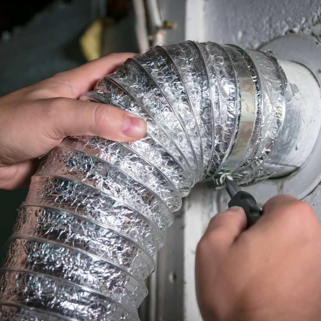 Thomas hvac team member professionally cleaning a dryer vent